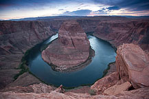 There wasn't a lot of color to the sunset last night, but I went with what I had.  Sunrise this morning was even worse.  Perfectly blue sky with no color at all.  I didn't bother making the trip to Horseshoe Bend.  Instead, I did laundry.  The domestic chores need to be done, and since I'm heading to Monument Valley tomorrow, and met a couple in a Casita that just came from there & mentioned that the price of washing & drying was twice what it is here, it's time.  After that I drove to Cottonwood Drive to see the South Narrows, a slot canyon.  Although nothing like the colorful Antelope Canyons, it was interesting in its own way.  Very peaceful, undeveloped, and 25 miles up an unimproved road from US 89.  The road had many interesting rock formations along the way.  One thing I don't understand is how power lines that run along a road always end up on the more interesting side.  If they were planned, they would be on the less impressive side, or if unplanned & following the law of averages they would be half & half, but on almost all the main or back roads I've driven power lines are always in the way!   I didn't go all the way up the canyon - I was by myself, and rock scrambling is not a good idea all alone that far from anywhere!  ￼ Rocks Along Cottonwood Drive off US 89   After that it was off to a car wash to remove 1/4" or red clay dust and back to Page-Lake Powell Campground for dinner.  I plan to take it easy this evening & get an early start tomorrow.Horseshoe Bend, Page, AZ